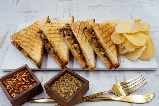 Savor this gourmet grilled mushroom sandwich served with crispy chips, perfect for a tasty meal.